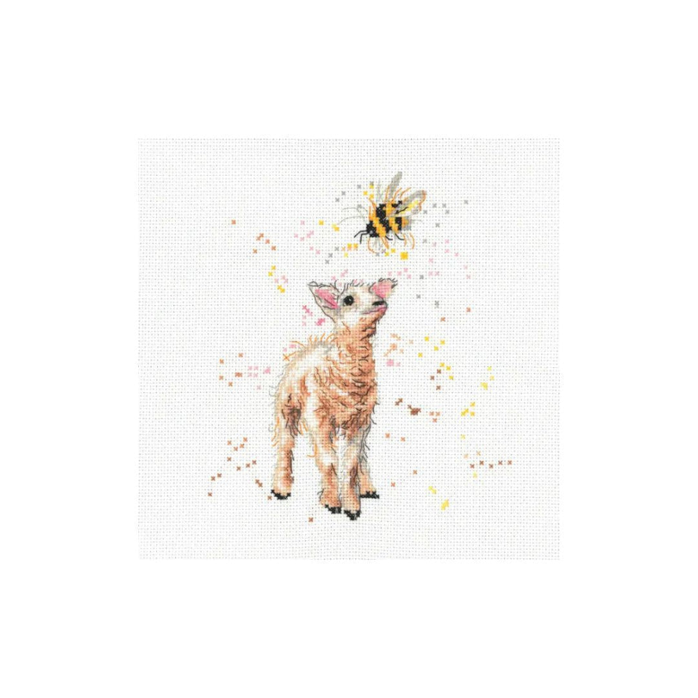 A cross-stitch pattern or art print featuring a small white lamb with pink accents and a yellow-and-black bumblebee above it, surrounded by delicate yellow and pink paint splatters on a white textured canvas background.