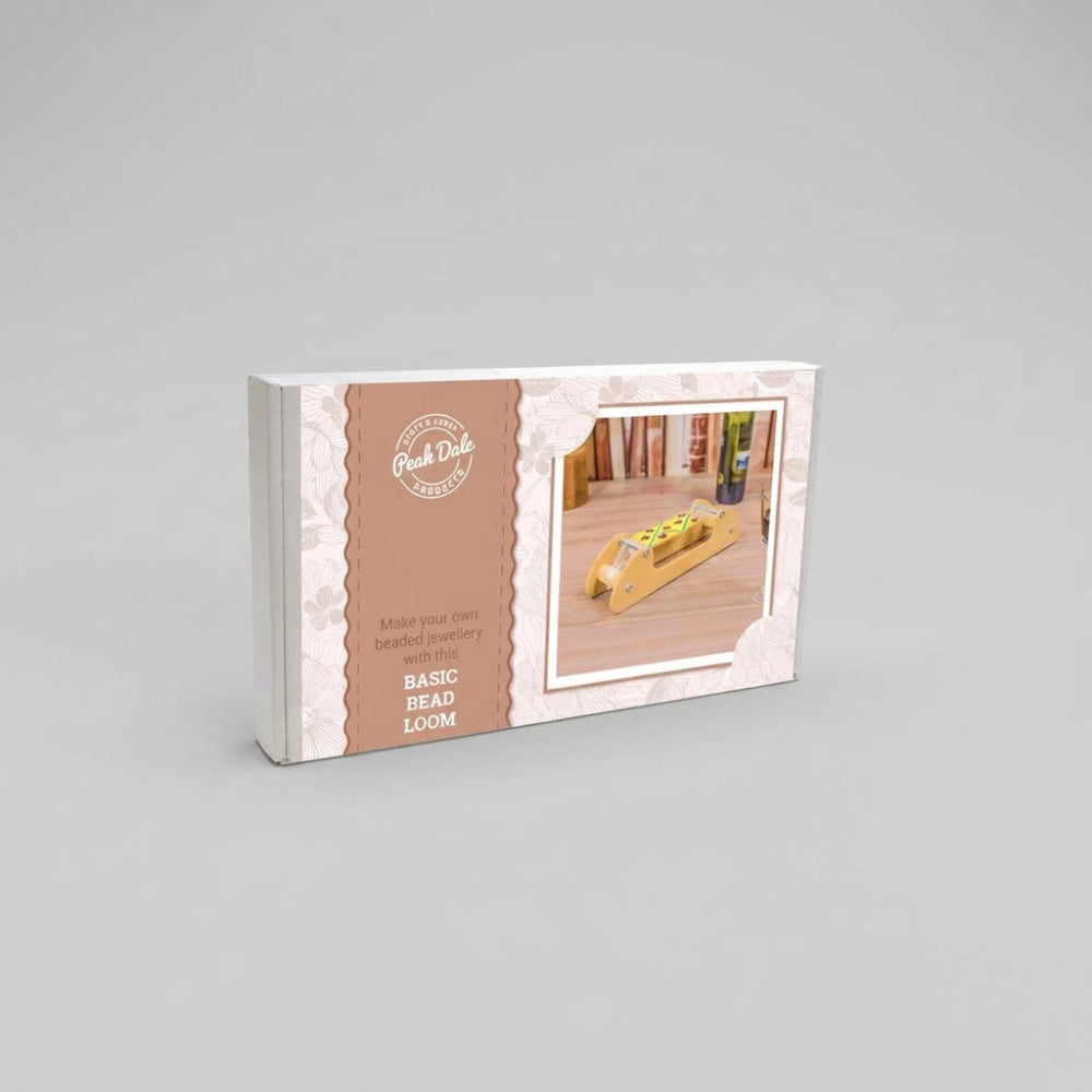 Packaging box for the 'Basic Bead Loom' by Peak Dale Products, featuring a brown and white design with a small inset photo of the wooden loom in use.