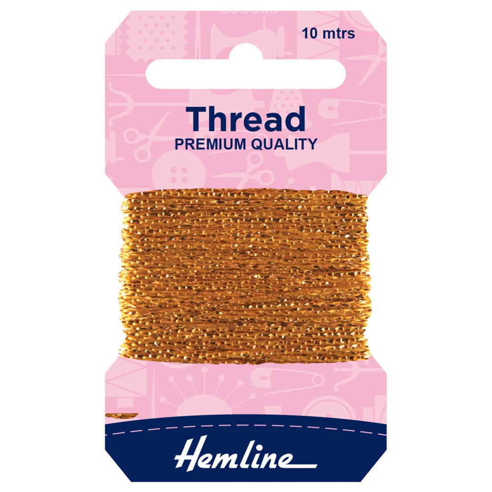 A package of Hemline premium quality gold sewing thread, 10 meters, wound on a cardboard spool with a pink header card and a navy blue brand label at the bottom.