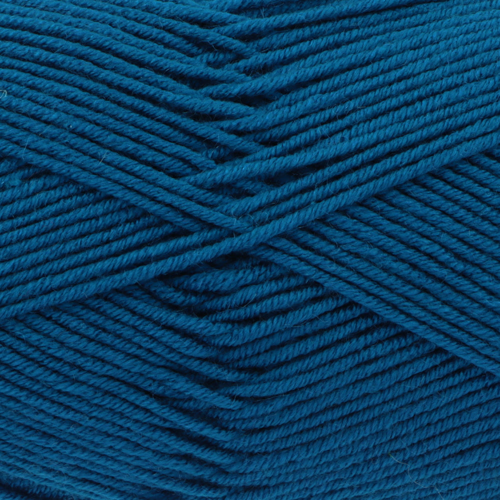 A close-up of textured blue yarn wound in diagonal layers, showing the twisted plies and fabric-like surface.