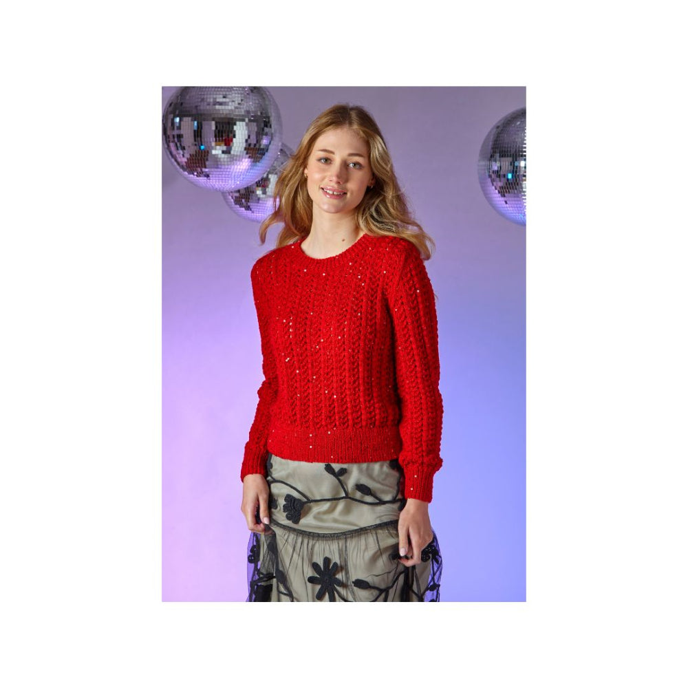 A woman modeling a bright red lace-knit sweater with sequined details, paired with a patterned skirt, set against a purple-lit background with disco ball props.