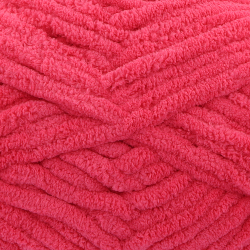 A close-up of bright pink fuzzy chenille yarn wound into thick skeins, showing the soft textured loops of the fabric.