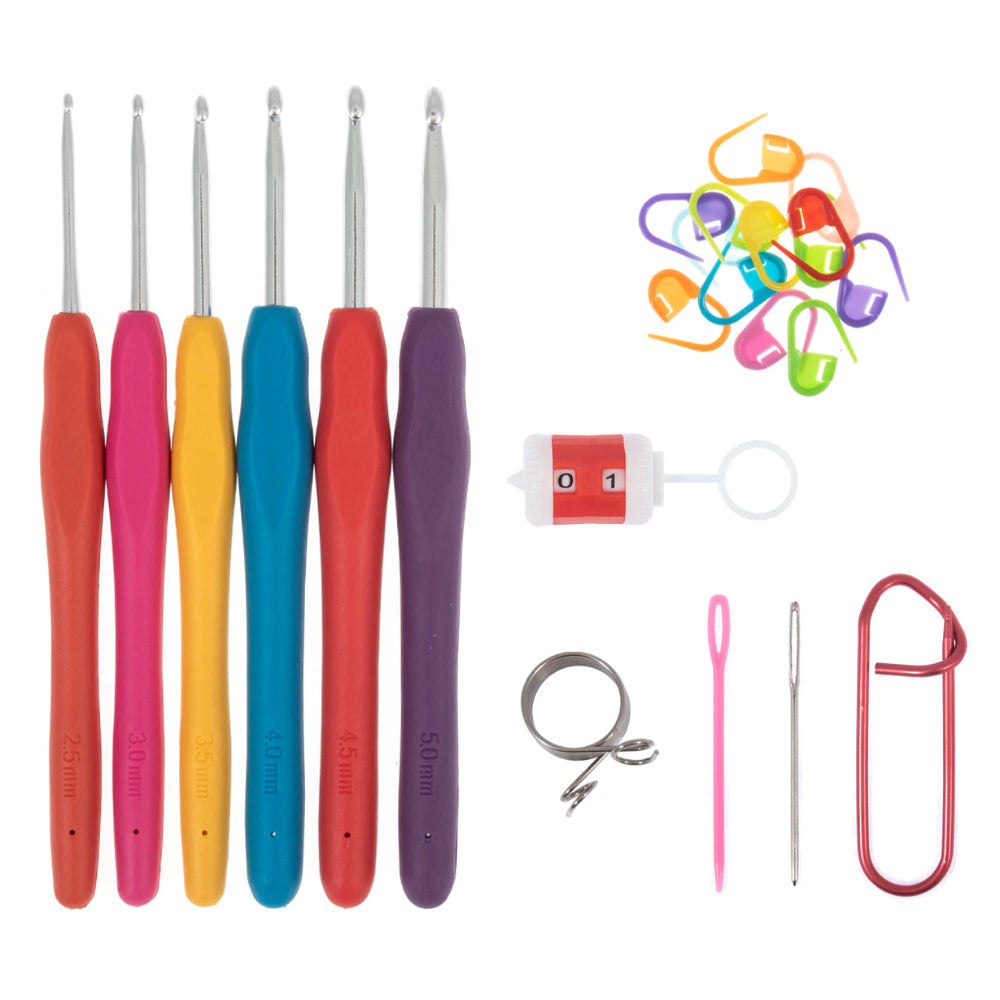 A crochet hook kit with six metal crochet hooks in orange, pink, yellow, blue, red, and purple handles, accompanied by colourful stitch markers, a stitch counter, a ring, a pink needle, a metal clip, and a white background.