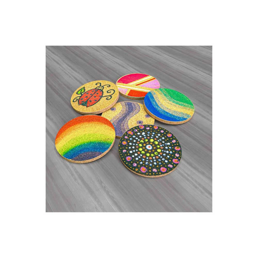 Five round wooden coasters with colourful painted designs, including a rainbow, a ladybug, and a mandala pattern, arranged on a grey wood-textured background.
