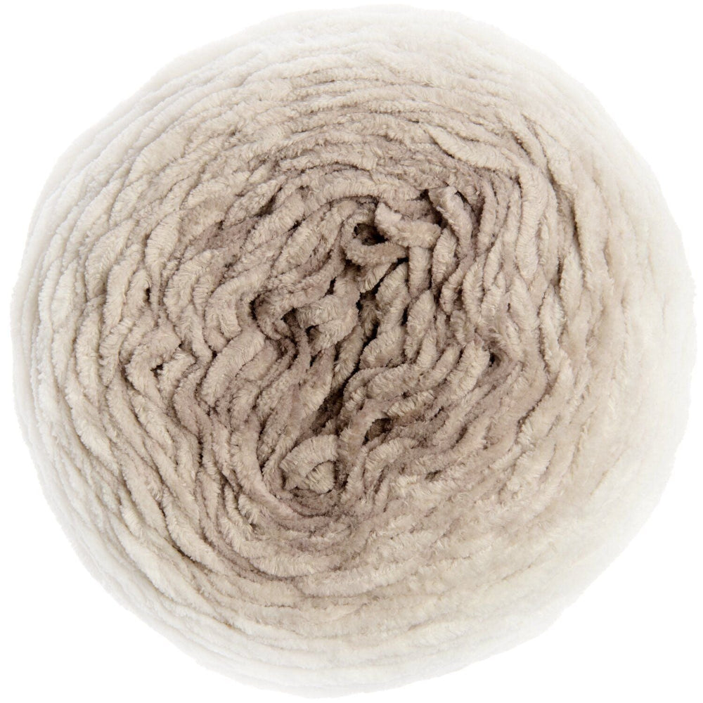 A top-down view of a large ball of chunky, curly yarn in a soft, multi-toned oatmeal beige color, isolated on a white background.