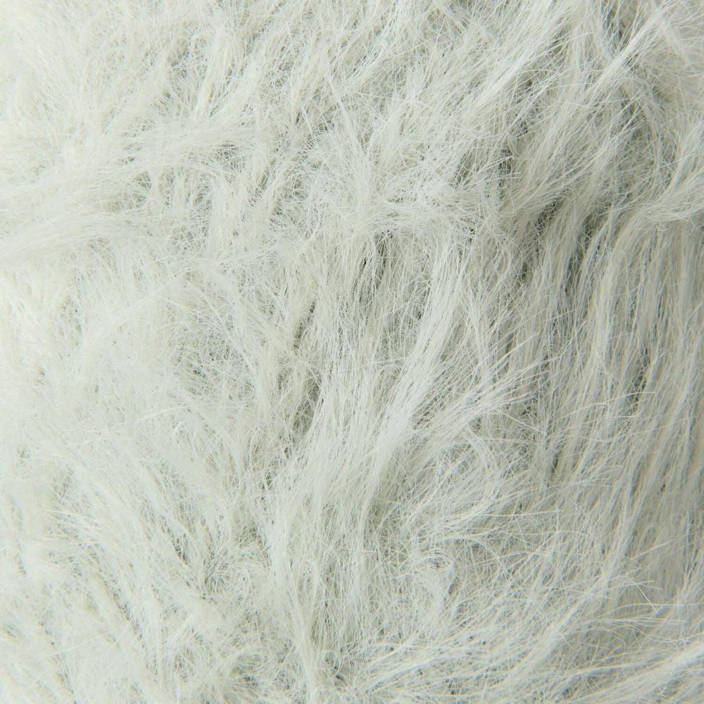 A close-up texture shot of fluffy faux fur fabric in a very light off-white color.