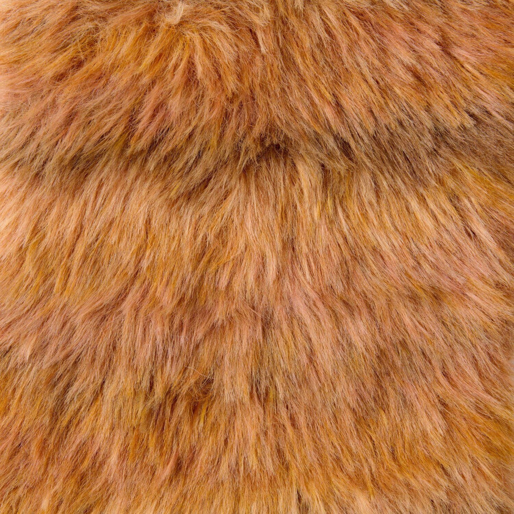 A close-up texture shot of shaggy faux fur fabric in a warm golden-brown color.