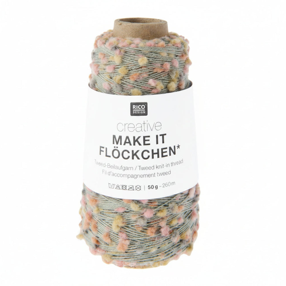 A spool of Rico Design Creative Make It Flockchen tweed knit-in thread, featuring a white paper label and a brown cardboard core, set against a plain white background.