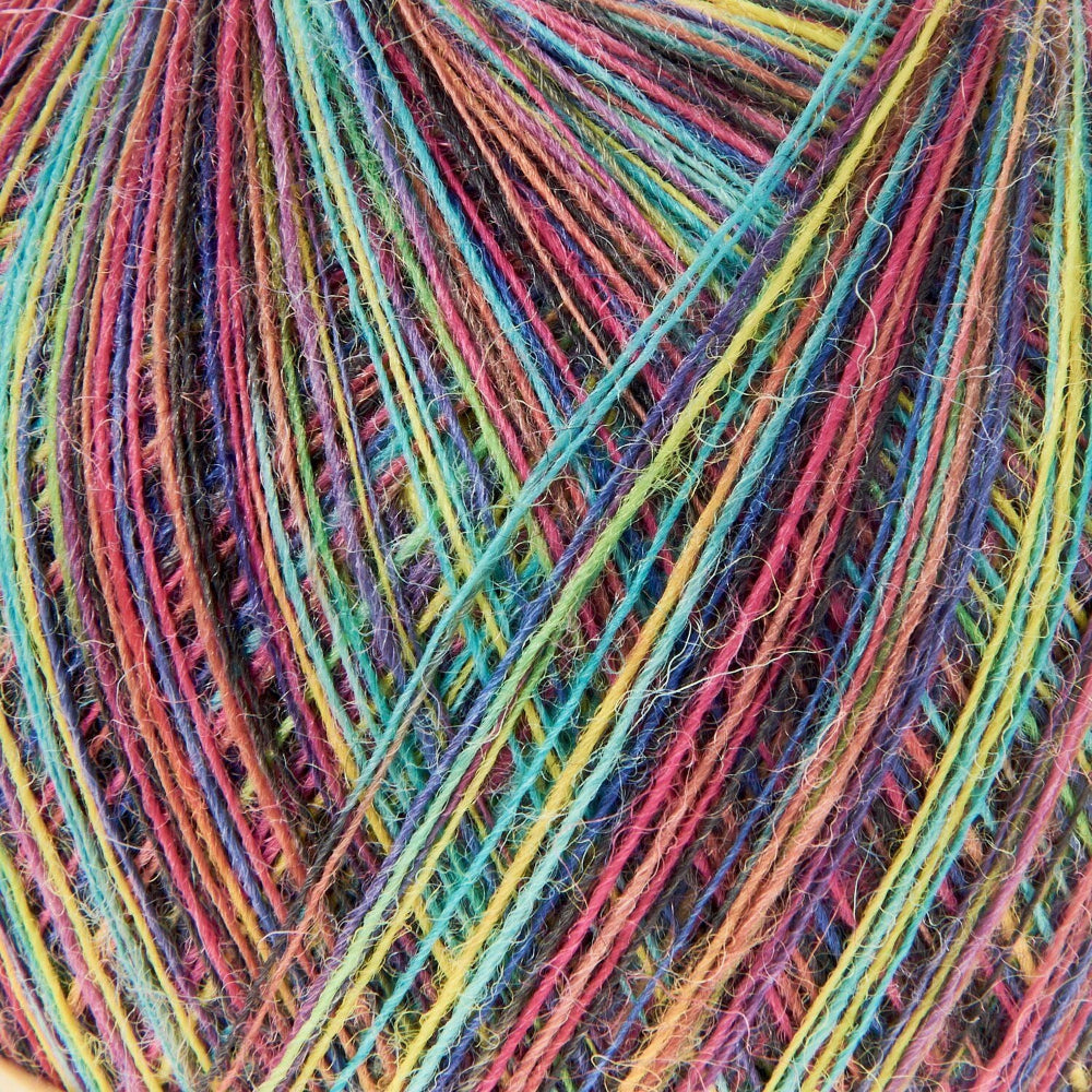 Close-up of multicolored yarn strands wound together, showing a rainbow mix of pink, blue, yellow, green, orange, and purple fibers.