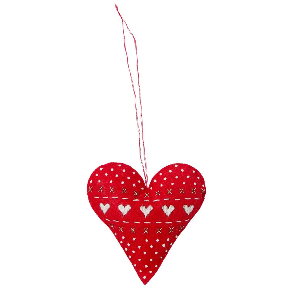 A red heart-shaped fabric hanging ornament with white embroidered hearts, dots, and stitched lines, suspended by a thin red string against a plain white background.
