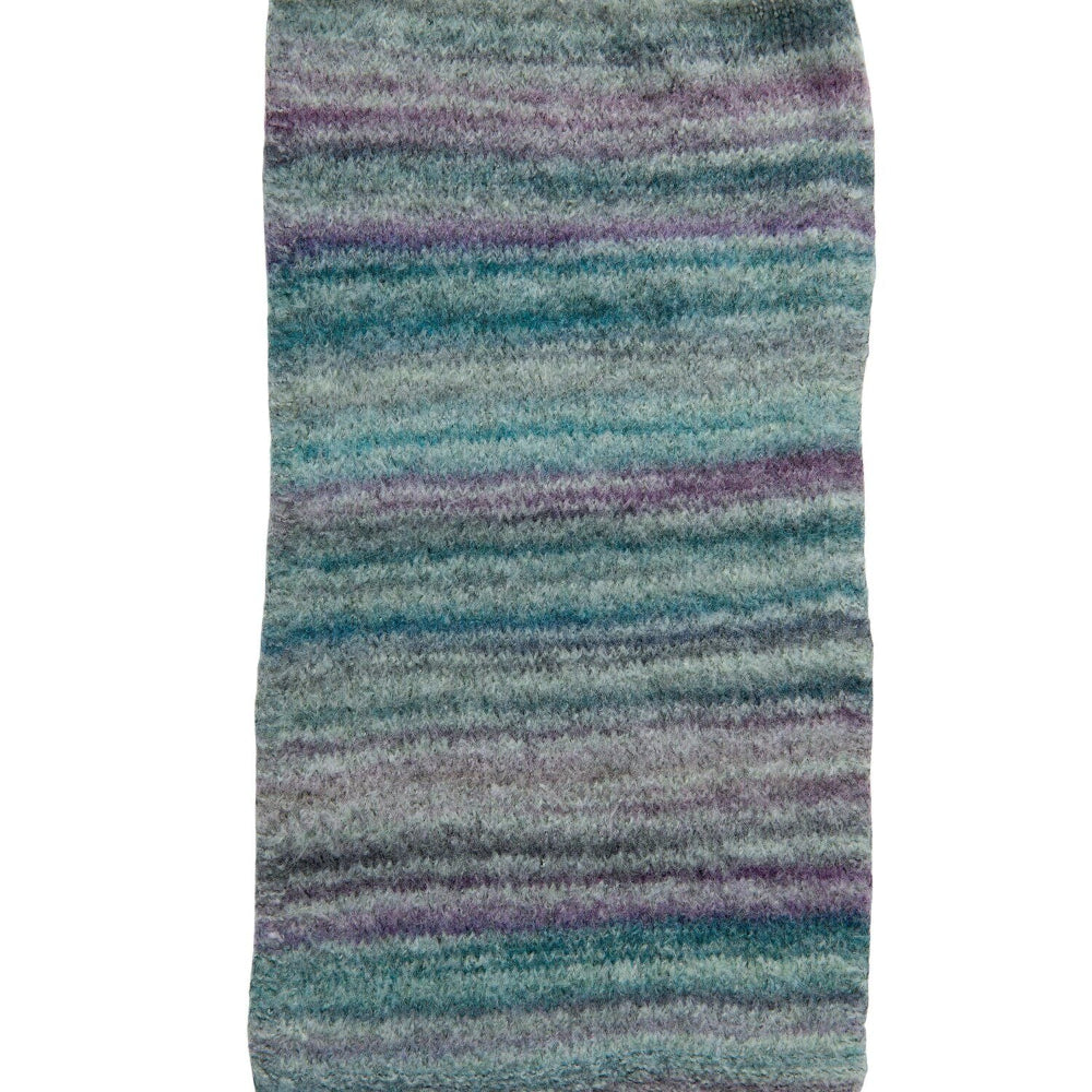 A rectangular area rug with a soft, plush texture featuring horizontal stripes in shades of teal, blue, purple, and gray on a white background.