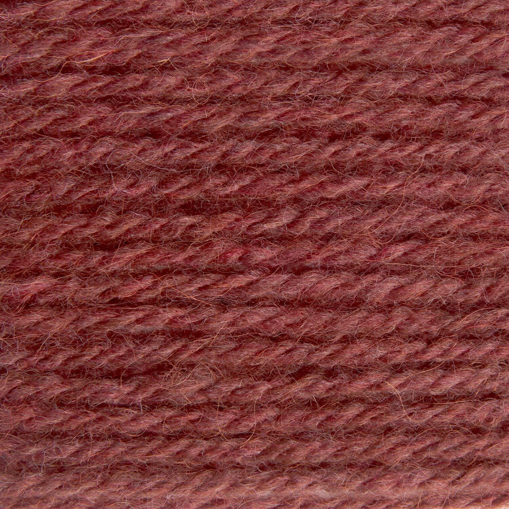 A close-up texture shot of twisted yarn in a dusty rose or mauve-brown color, filling the entire frame.