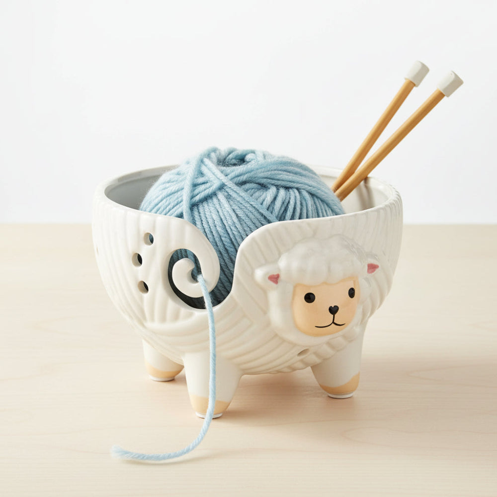 Ceramic sheep yarn holder with a white background