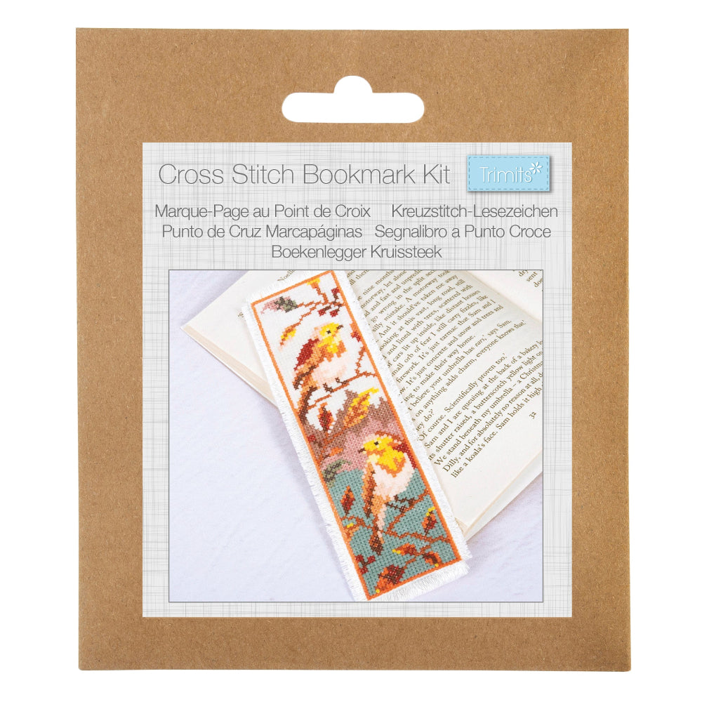 A cross stitch bookmark kit in its original brown kraft paper packaging, featuring a printed insert that shows a completed bookmark with a bird pattern.