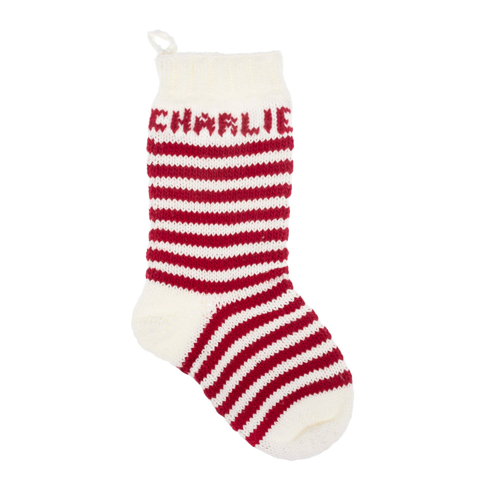 A single knitted Christmas stocking in off-white and dark red stripes, with the name 'CHARLIE' knitted in red across the cuff, shown on a plain white background.