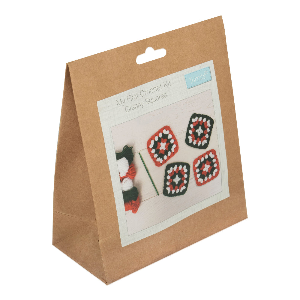 Kraft paper bag with a crochet kit on a white background