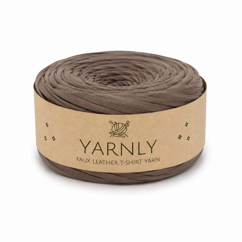 A roll of Yarnly faux leather T-shirt yarn in a taupe-brown color, wrapped in a kraft paper band with the brand name 'YARNLY' printed on it, set against a plain white background.