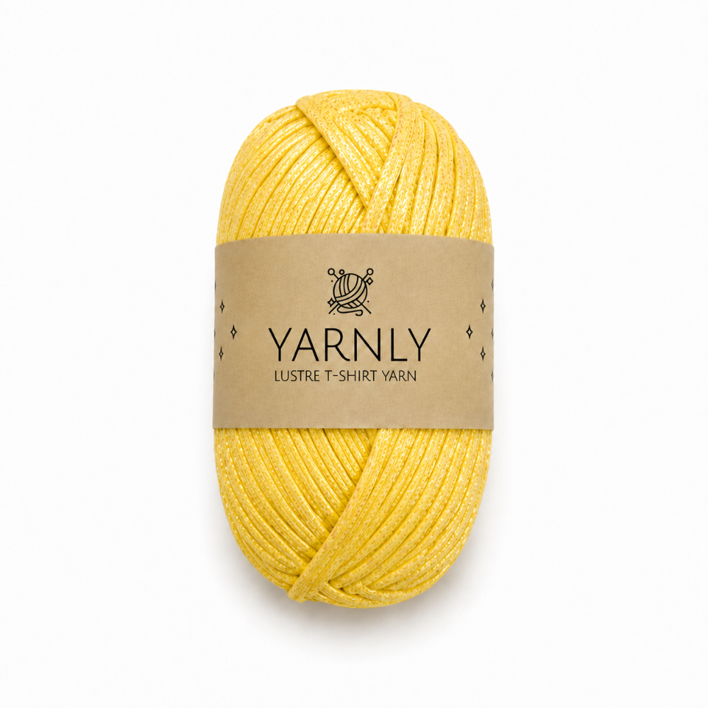 A skein of yellow yarn with a brown paper label reading 'YARNLY LUSTRE T-SHIRT YARN' on a plain white background.