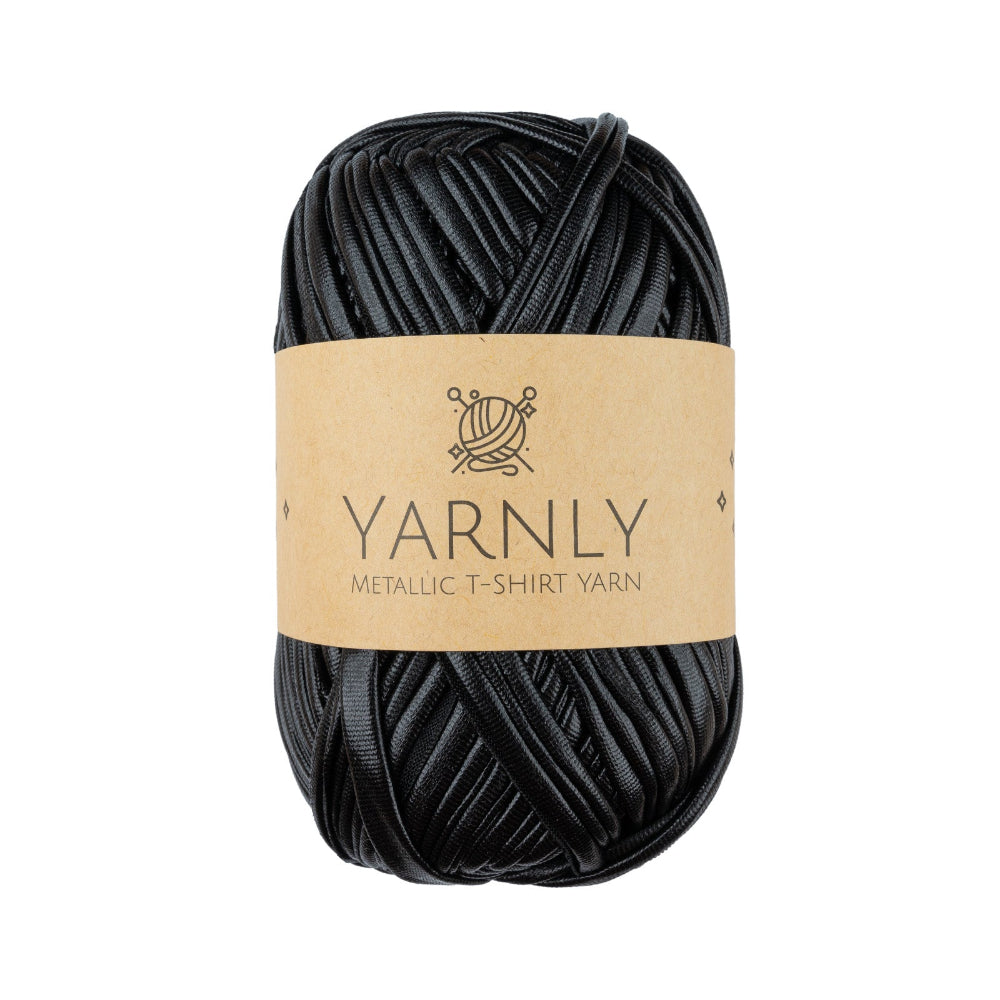 A skein of black metallic t-shirt yarn wrapped in a light brown paper band labeled 'YARNLY METALLIC T-SHIRT YARN' on a plain white background.