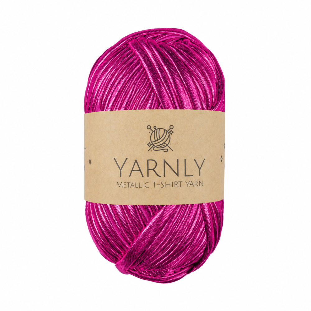 A skein of metallic fuchsia pink yarn with a brown paper label reading 'YARNLY METALLIC T-SHIRT YARN' on a plain white background.
