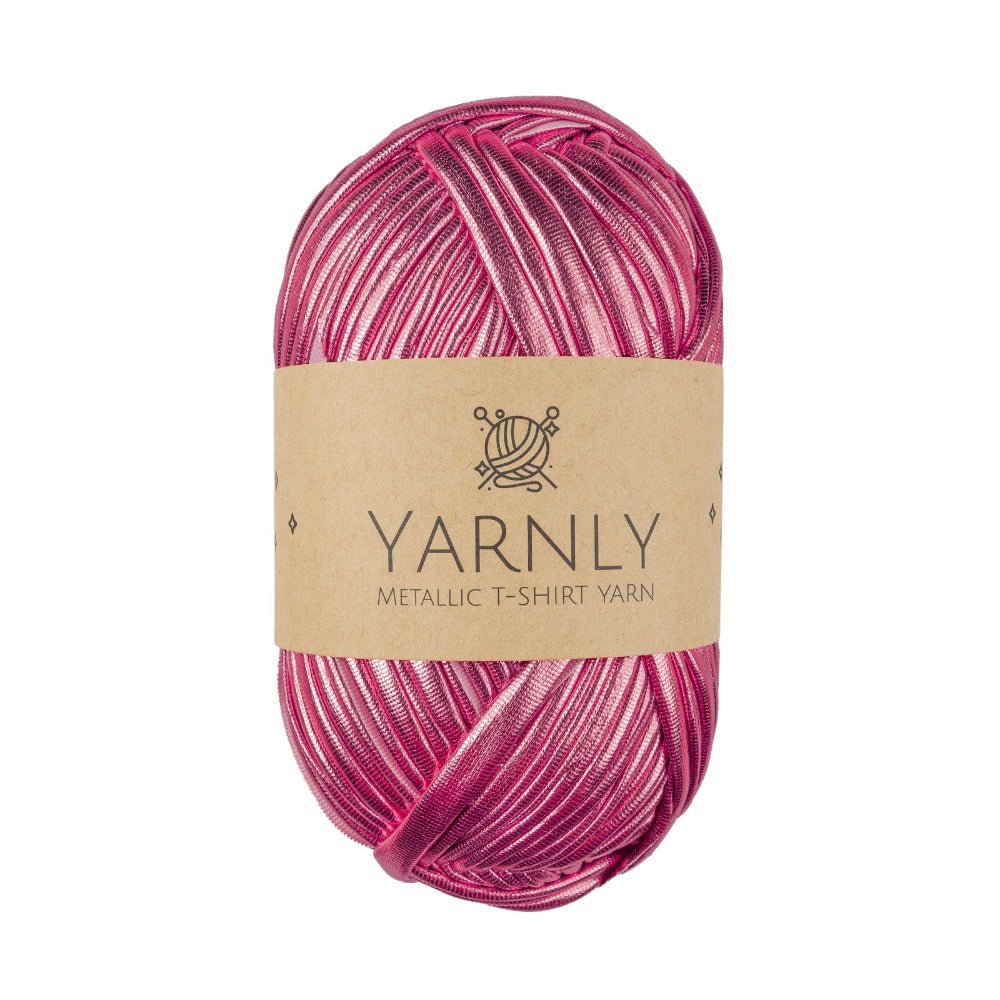 A single skein of Yarnly Metallic T-Shirt Yarn in a metallic magenta-pink and purple striped pattern, wrapped with a brown paper label, on a solid white background.