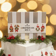 A white Ricorumi Christmas Cal Box 6 gift box with gold stripes and holiday-themed hanging ornament illustrations, displayed on a white shelf.
