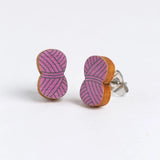 Yarn ball shaped earrings with pink and brown design on a white background