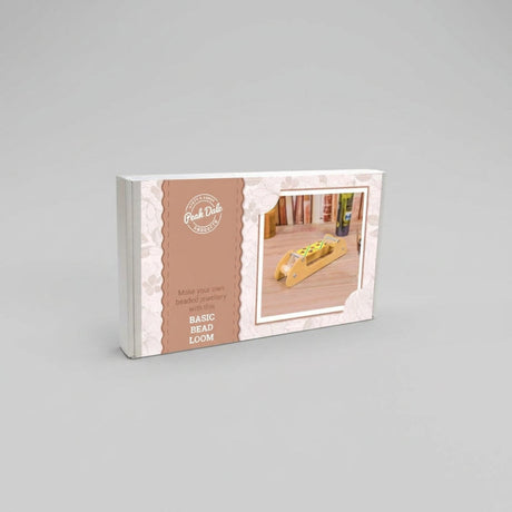 Packaging box for the 'Basic Bead Loom' by Peak Dale Products, featuring a brown and white design with a small inset photo of the wooden loom in use.