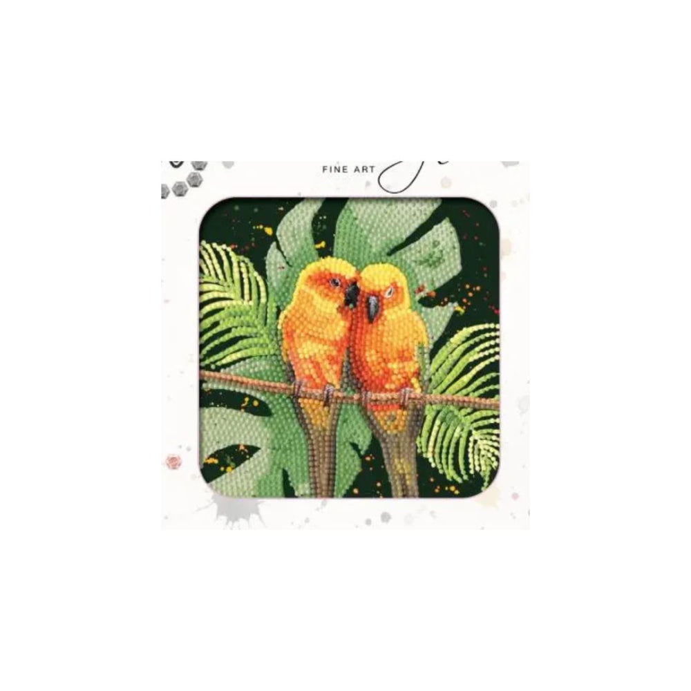 A diamond painting kit or art print featuring two orange-yellow birds perched on a branch with green tropical leaves, presented in a white square frame with 'FINE ART' text at the top.