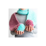 A person wearing a chunky knit scarf and matching fuzzy fingerless gloves in pastel pink, aqua, and grey, shown against a plain white background.