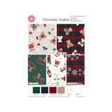 A fabric design sheet titled 'Christmas Toybox' showing six holiday-themed pattern options with teddy bears, plaid, snowflakes, Santa, and Christmas motifs, plus colour swatches and small printed notes at the bottom.