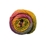A single skein of variegated yarn with a spiral colour gradient of yellow, orange, pink, purple, and olive green, accented with fine silver glitter, shown on a plain white background.