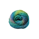 A single ball of variegated yarn with a gradient of teal, blue, green, and hints of purple, isolated on a solid white background.