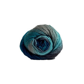 A single ball of variegated yarn with a colour-changing gradient from grey and teal to deep blue, isolated on a solid white background.
