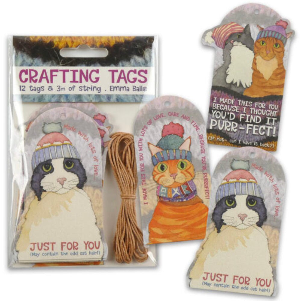 Pack of cat-themed crafting tags and string on a white background, with one tag shown unfolded and the others in the clear plastic package. The tags feature illustrated cats wearing knit hats and colorful text including 'CRAFTING TAGS' and 'JUST FOR YOU'.