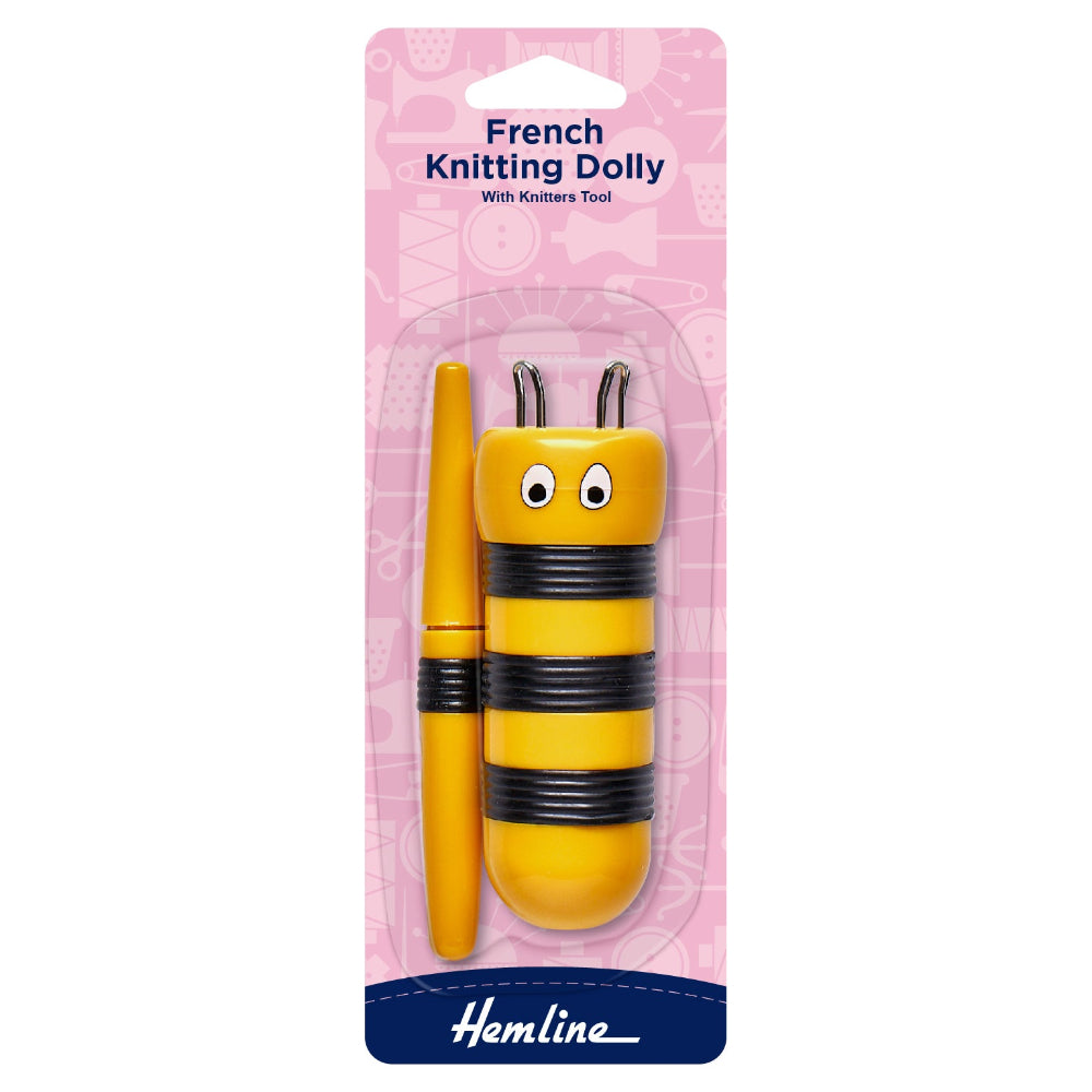 Yellow French knitting dolly with black stripes on pink packaging, featuring the brand 'Hemline'.