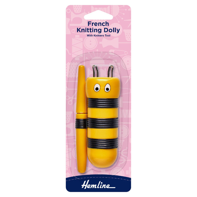 Yellow French knitting dolly with black stripes on pink packaging, featuring the brand 'Hemline'.