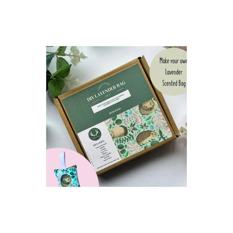 A kraft paper box labeled 'DIY LAVENDER BAG' with illustrated floral and leaf artwork on the lid, shown on a light background with decorative green leaves and a small inset of a finished lavender bag. Text on the image reads 'Make your own Lavender Scented Bag.