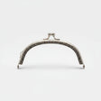 A silver metal bag clasp with clear rhinestones, presented in its pink retail packaging by Hemline.