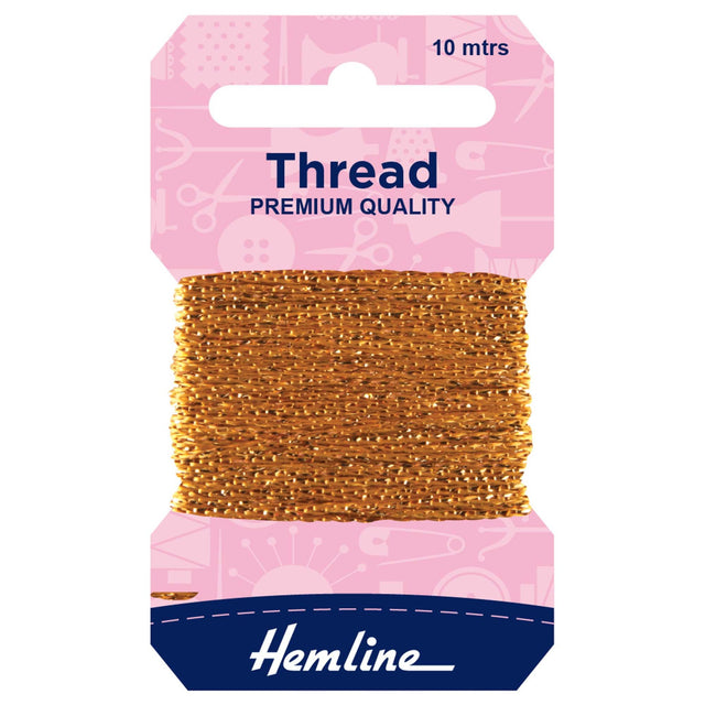 A package of Hemline premium quality gold sewing thread, 10 meters, wound on a cardboard spool with a pink header card and a navy blue brand label at the bottom.