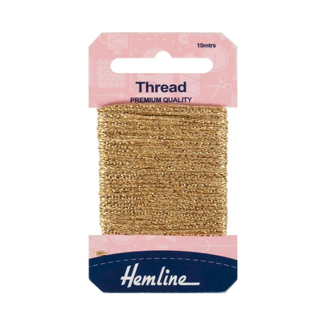 A 10-meter spool of Hemline light gold embroidery thread in its original pink and navy blue retail packaging, shown against a plain white background.