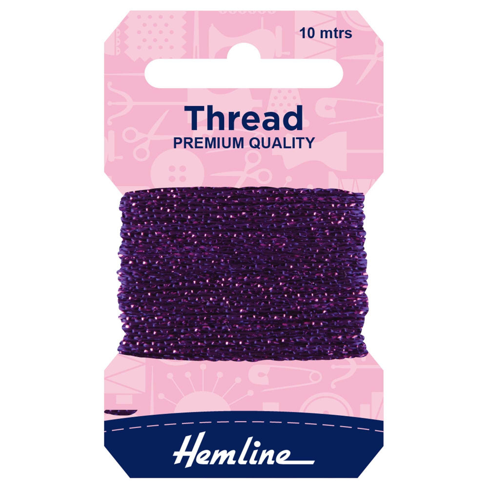 A package of Hemline thread spool, featuring a dark purple thread wound around a cardboard hanger with a pink top card and a navy blue bottom section.