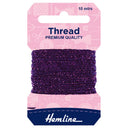 A package of Hemline thread spool, featuring a dark purple thread wound around a cardboard hanger with a pink top card and a navy blue bottom section.