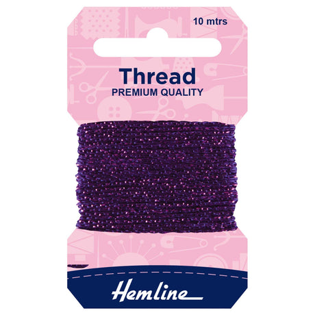 A package of Hemline thread spool, featuring a dark purple thread wound around a cardboard hanger with a pink top card and a navy blue bottom section.