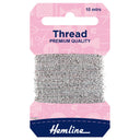A package of Hemline silver sewing thread wound around a cardboard hanger, with a pink header card and a navy blue brand section at the bottom.
