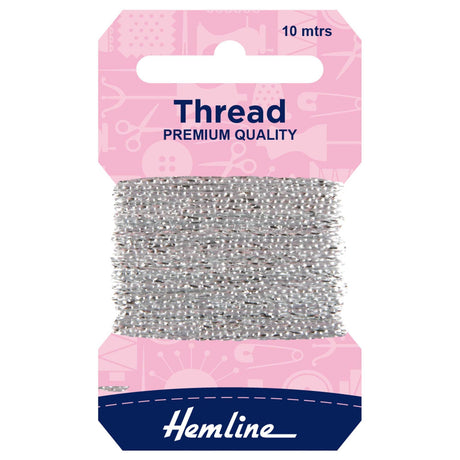 A package of Hemline silver sewing thread wound around a cardboard hanger, with a pink header card and a navy blue brand section at the bottom.