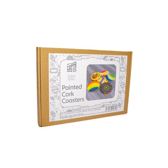 A cardboard box for a 'Painted Cork Coasters' kit, featuring a white label with a photo of colourful painted coasters and the brand name 'The Cork Coaster Company'.