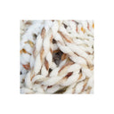 A close-up of chunky, thick yarn with a variegated colour pattern of white, light brown, and soft orange, presented on a clean white background.