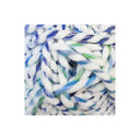 A close-up of thick, fuzzy yarn with a variegated colour pattern of white, blue, and green, presented on a clean white background.
