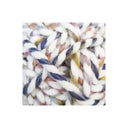 A close-up of chunky twisted yarn with a variegated colour pattern of white, navy blue, dusty pink, and yellow.